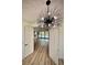 Elegant entryway with chandelier and view of the living room at 225 Tournament Rd, Rotonda West, FL 33947