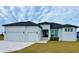 Beautiful modern home with two-car garage and landscaped lawn at 225 Tournament Rd, Rotonda West, FL 33947