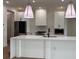 Modern kitchen with white cabinets and large island at 225 Tournament Rd, Rotonda West, FL 33947