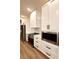 Modern kitchen with stainless steel appliances and white cabinets at 225 Tournament Rd, Rotonda West, FL 33947