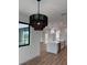 Open concept kitchen with an island and modern lighting at 225 Tournament Rd, Rotonda West, FL 33947