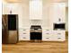 Modern kitchen with stainless steel appliances and white cabinets at 225 Tournament Rd, Rotonda West, FL 33947