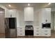 Modern kitchen features stainless steel appliances and white cabinetry at 225 Tournament Rd, Rotonda West, FL 33947