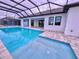 Inviting pool area with a screened enclosure at 225 Tournament Rd, Rotonda West, FL 33947