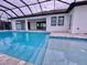 Inviting pool area with covered patio and lush landscaping at 225 Tournament Rd, Rotonda West, FL 33947