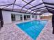Inviting pool area with a screened enclosure at 225 Tournament Rd, Rotonda West, FL 33947