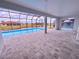 Spacious pool patio with screened enclosure and water view at 225 Tournament Rd, Rotonda West, FL 33947