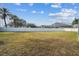 Expansive grassy backyard with a view of the pool and fence at 23201 Eagles Watch Dr, Land O Lakes, FL 34639