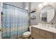 Bathroom with a vanity, toilet, and patterned shower curtain at 23201 Eagles Watch Dr, Land O Lakes, FL 34639