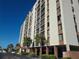 Multi-story building with parking and palm trees at 255 Dolphin Pt # 511, Clearwater Beach, FL 33767