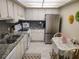 Bright kitchen with granite counters and stainless steel appliances at 255 Dolphin Pt # 511, Clearwater Beach, FL 33767