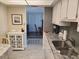 Kitchen with granite countertops and white cabinets at 255 Dolphin Pt # 511, Clearwater Beach, FL 33767