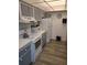 Well-equipped kitchen with white appliances and gray cabinets at 255 Dolphin Pt # 511, Clearwater Beach, FL 33767
