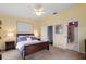 Spacious bedroom with a king-size bed, ceiling fan, and en-suite bathroom at 274 Madeira Cir, St Petersburg, FL 33715
