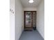 Inviting entryway with a brown door and a potted plant at 274 Madeira Cir, St Petersburg, FL 33715
