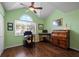 Bright home office features wood floors, built-in shelves, and a vaulted ceiling at 274 Madeira Cir, St Petersburg, FL 33715