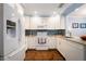 White cabinets, granite countertops, and stainless steel appliances in this galley kitchen at 274 Madeira Cir, St Petersburg, FL 33715