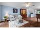 Living room with hardwood floors, sofa, and wooden cabinet at 274 Madeira Cir, St Petersburg, FL 33715
