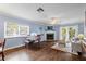 Spacious living room with hardwood floors, fireplace, and piano at 274 Madeira Cir, St Petersburg, FL 33715