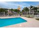 Community pool area with lounge chairs and thatch umbrellas at 274 Madeira Cir, St Petersburg, FL 33715