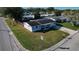 Aerial view of a house on a corner lot in a residential area at 3005 Matchlock Dr, Holiday, FL 34690