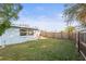 Spacious backyard with grassy area and wooden fence at 3005 Matchlock Dr, Holiday, FL 34690