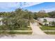 Aerial view of a single-Gathering home with a large tree in the front yard at 3048 Orchard Dr, Palm Harbor, FL 34684