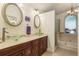 Elegant bathroom with dual vanities, glass sinks, and a soaking tub at 3048 Orchard Dr, Palm Harbor, FL 34684