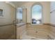 Modern bathroom with a large walk-in shower and a soaking tub at 3048 Orchard Dr, Palm Harbor, FL 34684