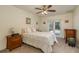 Bright bedroom with a queen-size bed, pool view, and ceiling fan at 3048 Orchard Dr, Palm Harbor, FL 34684