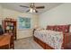 Cozy bedroom with a daybed, built-in shelves, and ceiling fan at 3048 Orchard Dr, Palm Harbor, FL 34684
