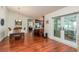 Dining room with hardwood floors and access to kitchen and patio at 3048 Orchard Dr, Palm Harbor, FL 34684
