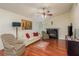 Living room with hardwood floors, a sofa, and a fireplace at 3048 Orchard Dr, Palm Harbor, FL 34684