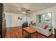 Living room with hardwood floors, a couch, and a ceiling fan at 3048 Orchard Dr, Palm Harbor, FL 34684
