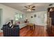 Living room with hardwood floors, comfy seating, and ceiling fan at 3048 Orchard Dr, Palm Harbor, FL 34684