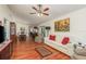 Open living room with hardwood floors and view into dining area at 3048 Orchard Dr, Palm Harbor, FL 34684