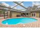 Large kidney-shaped pool with covered patio at 3048 Orchard Dr, Palm Harbor, FL 34684