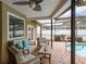 Covered patio furniture near the pool at 3048 Orchard Dr, Palm Harbor, FL 34684