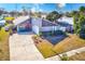 Home features a two-car garage and well-manicured lawn at 3113 Chamblee Ln, Clearwater, FL 33759
