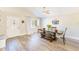 Bright dining room with hardwood floors and a farmhouse table at 3113 Chamblee Ln, Clearwater, FL 33759