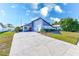 Cute Florida home with gray exterior, red door, and nicely landscaped lawn at 3113 Chamblee Ln, Clearwater, FL 33759