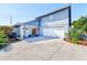 Gray and white house with a red door and landscaping at 3113 Chamblee Ln, Clearwater, FL 33759