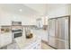 Modern kitchen with white cabinets, granite countertops, and stainless steel appliances at 3113 Chamblee Ln, Clearwater, FL 33759