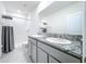 Bathroom with double sinks, granite countertop, and shower at 32535 Turtle Grace Loop, Wesley Chapel, FL 33545