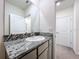 Modern bathroom with granite countertop and gray vanity at 32535 Turtle Grace Loop, Wesley Chapel, FL 33545