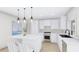 Modern kitchen with white cabinets, marble island, and stainless steel appliances at 3307 W Oak Ave, Plant City, FL 33563