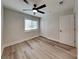 Bright bedroom with ceiling fan and vinyl plank flooring at 4411 Mongite Rd, North Port, FL 34287