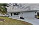 White house with a white picket fence and a two-car garage at 4411 Mongite Rd, North Port, FL 34287