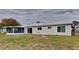 Rear view of the house showcasing the screened patio and yard at 4411 Mongite Rd, North Port, FL 34287