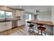 Modern kitchen with white cabinets, stainless steel appliances, and a breakfast bar at 4411 Mongite Rd, North Port, FL 34287